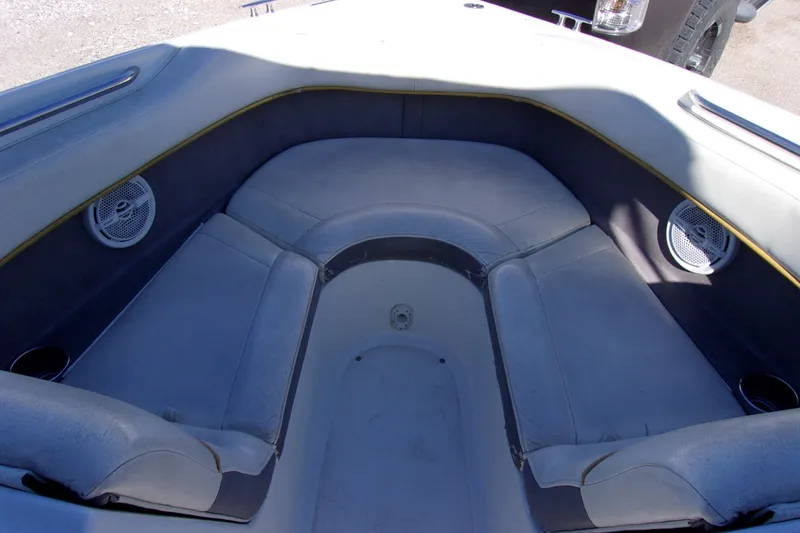 Slide: The Image of Interior of a 2005 Cobalt 200 boat with cushioned seating and speakers. - 13