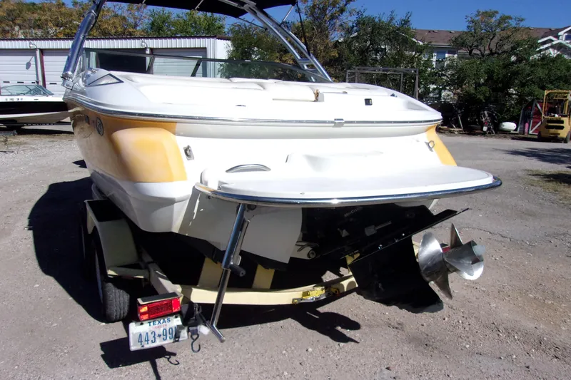Slide: The Image of 2005 Cobalt 200 boat on trailer, rear view with propeller, parked outdoors. - 3