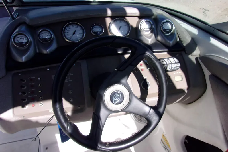 Slide: The Image of Steering wheel and dashboard of a 2005 Cobalt 200 boat, featuring gauges and controls. - 6