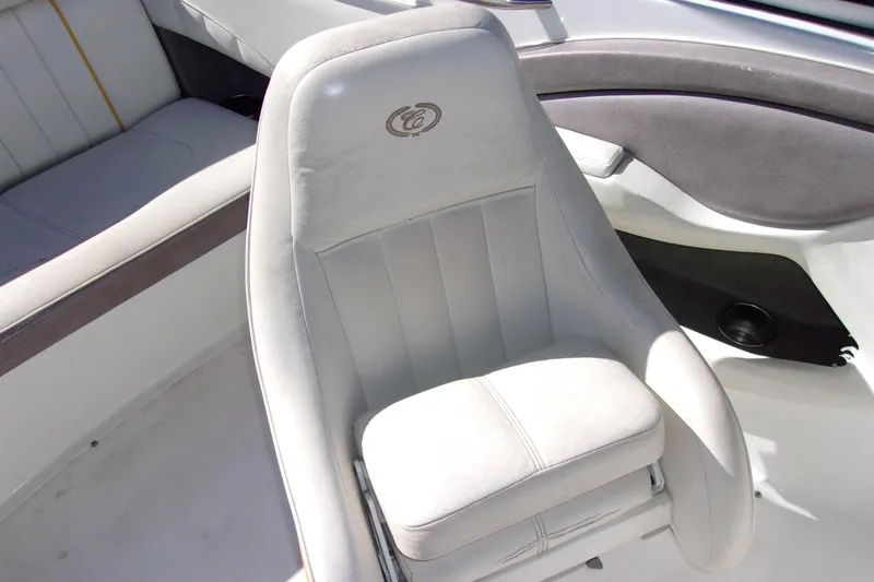 Slide: The Image of 2005 Cobalt 200 boat interior with white cushioned seating. - 9