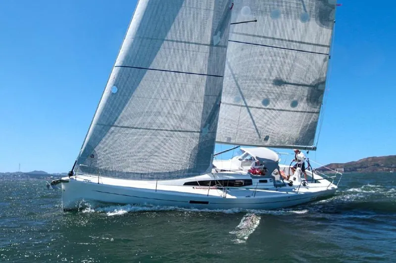 The Image of 2021 J Boats J/112E sailing on open water under clear blue skies. - 0