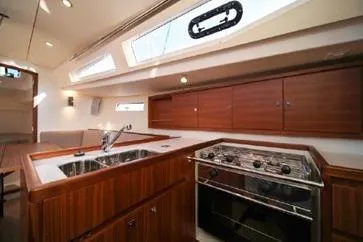 Slide: The Image of 2021 J Boats J/112E yacht interior with modern kitchen and wooden cabinetry. - 11