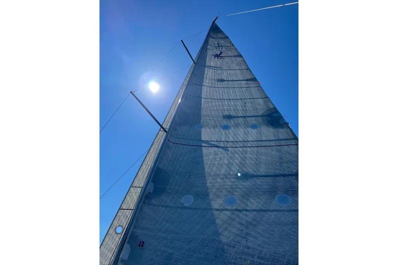 Slide: The Image of Sail of 2021 J Boats J/112E yacht against clear blue sky. - 16