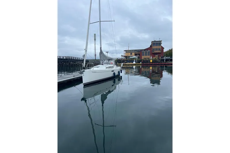 Slide: The Image of 2021 J Boats J/112E sailboat docked in calm marina waters, overcast sky. - 18