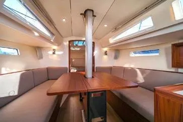 Slide: The Image of 2021 J Boats J/112E interior with spacious seating and wooden table. - 4