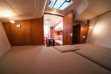 Slide: The Image of 2021 J Boats J/112E interior cabin with wood finish and cozy bedding. - 9