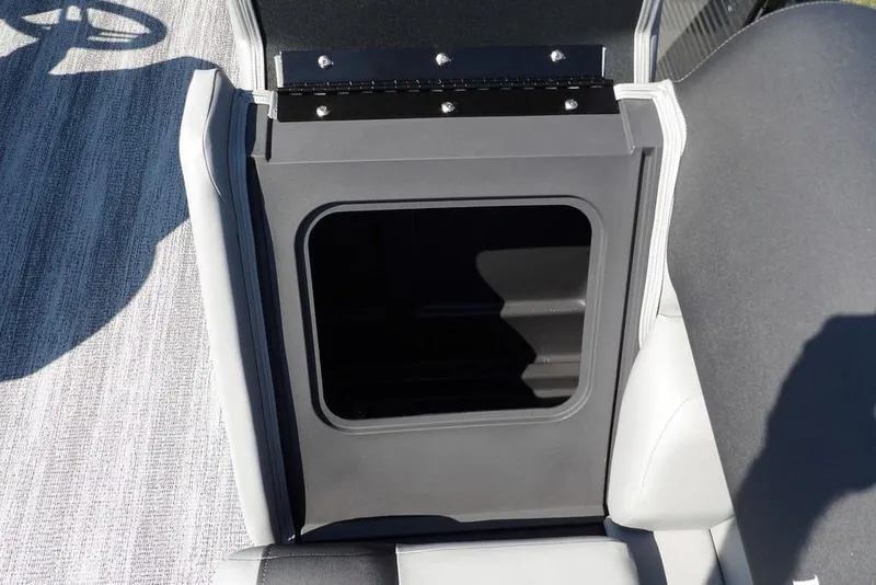 Slide: The Image of 2026 Bennington S Quad Bench 22 SSR storage compartment with open lid, showcasing interior space. - 11