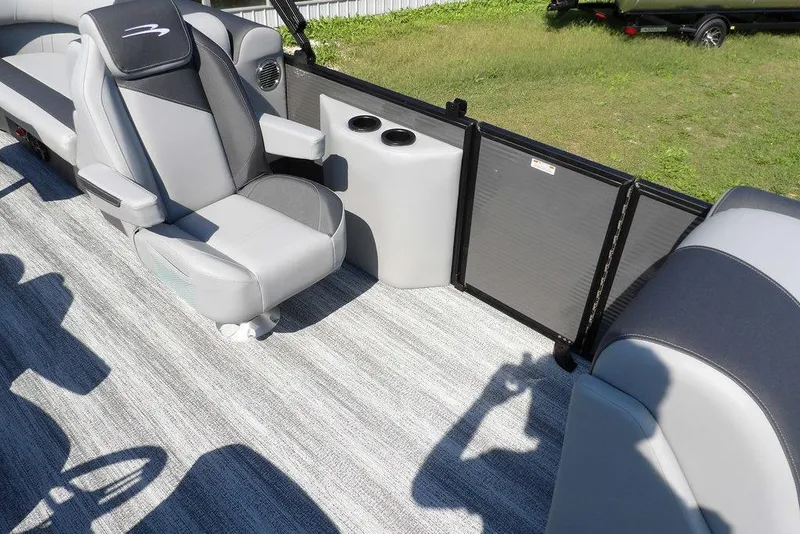 Slide: The Image of 2026 Bennington S Quad Bench 22 SSR interior with gray seating and cup holders. - 17