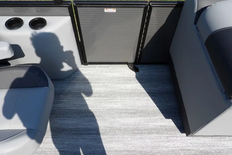 Slide: The Image of 2026 Bennington S Quad Bench 22 SSR interior with gray seating and shadow on carpet. - 18