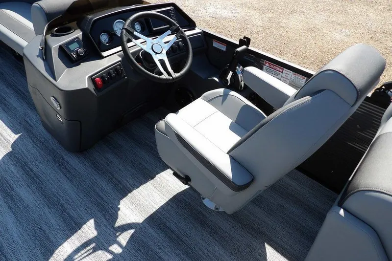 Slide: The Image of 2026 Bennington S Quad Bench 22 SSR boat interior with steering wheel and seating. - 23