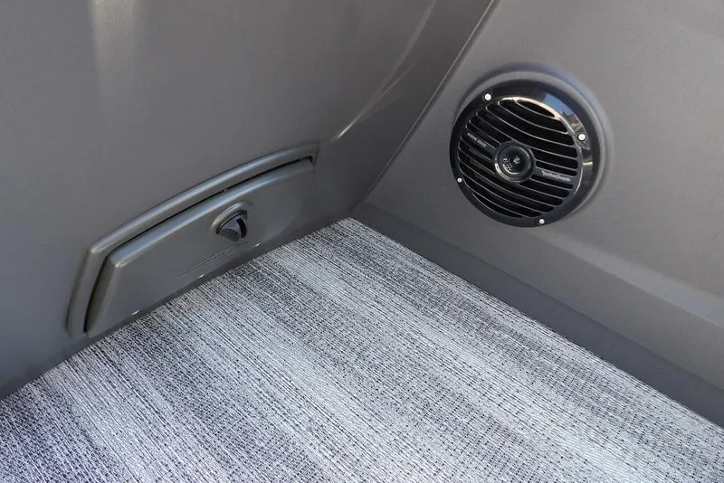 Slide: The Image of 2026 Bennington S Quad Bench 22 SSR interior speaker and storage compartment. - 31