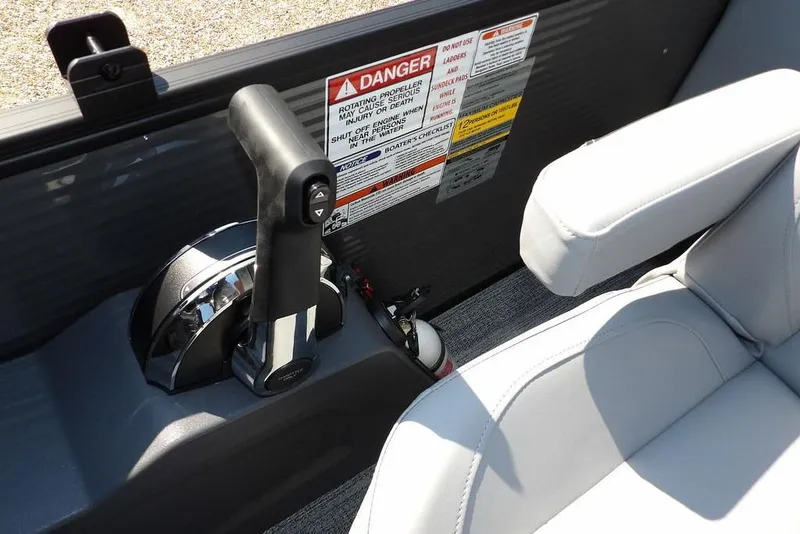 Slide: The Image of 2026 Bennington S Quad Bench 22 SSR boat throttle and seat with safety warnings. - 34