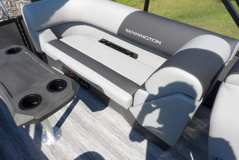 Slide: The Image of 2026 Bennington S Quad Bench 22 SSR interior with gray seating and cup holders. - 37