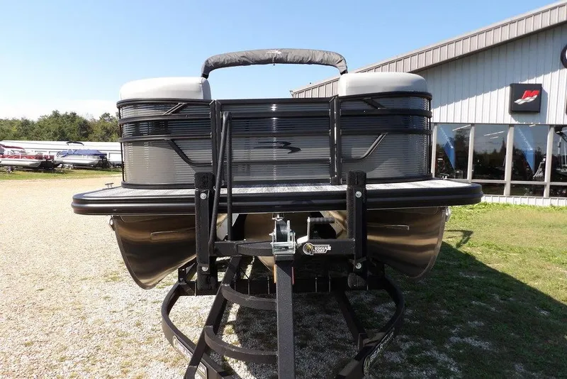 Slide: The Image of 2026 Bennington S Quad Bench 22 SSR pontoon boat on trailer, outdoor dealership display. - 4