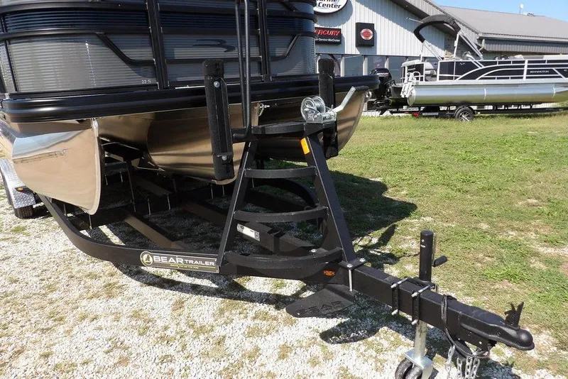 Slide: The Image of 2026 Bennington S Quad Bench 22 SSR on Bear trailer, parked on grass. - 41