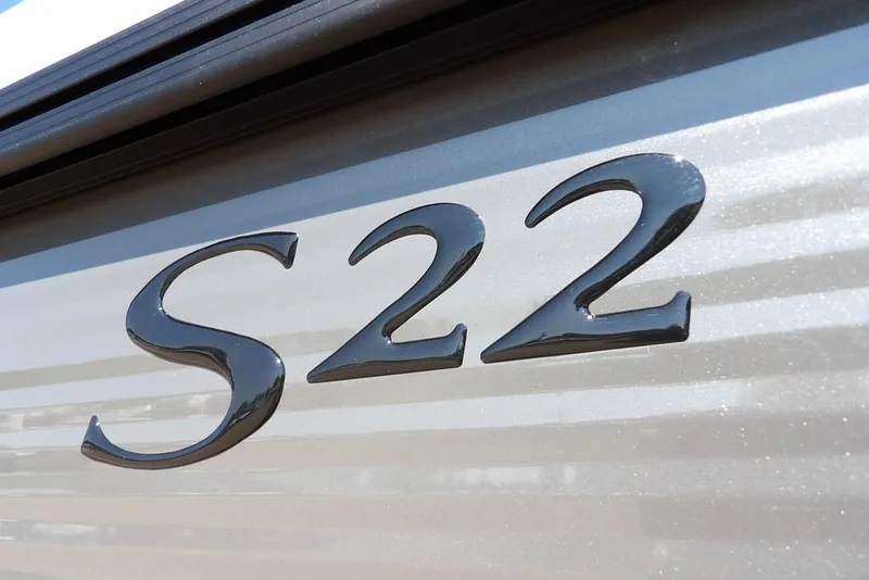 Slide: The Image of Close-up of 2026 Bennington S Quad Bench 22 SSR model emblem. - 45