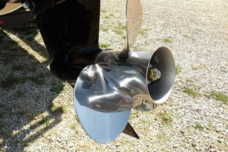 Slide: The Image of 2026 Bennington S Quad Bench 22 SSR boat propeller on gravel surface. - 53