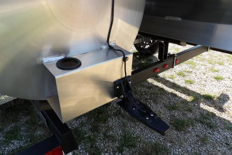 Slide: The Image of Trailer hitch of 2026 Bennington S Quad Bench 22 SSR on gravel surface. - 54
