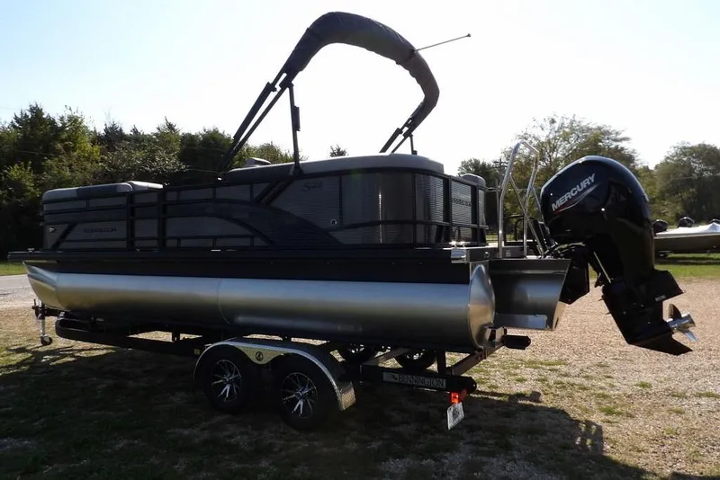 Slide: The Image of 2026 Bennington S Quad Bench 22 SSR pontoon boat with Mercury outboard motor on trailer. - 9
