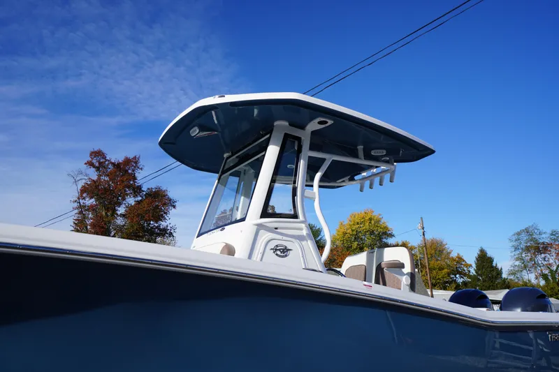 Slide: The Image of 2026 Tidewater 256 CC Adventure boat under clear blue sky. - 1