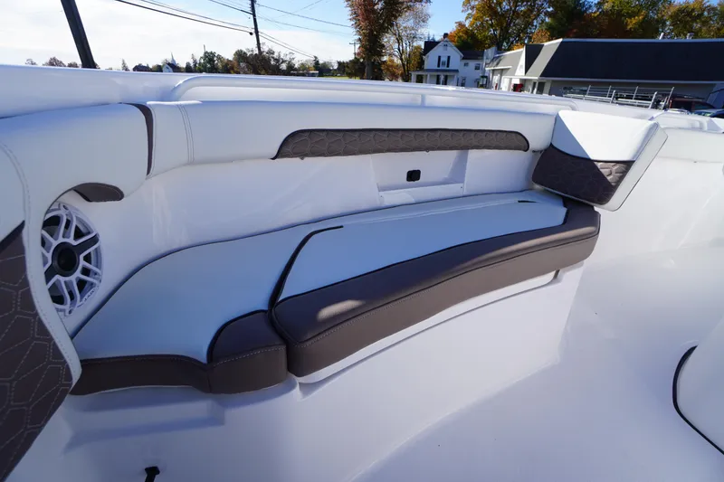 Slide: The Image of 2026 Tidewater 256 CC Adventure boat interior with cushioned seating and speakers. - 12