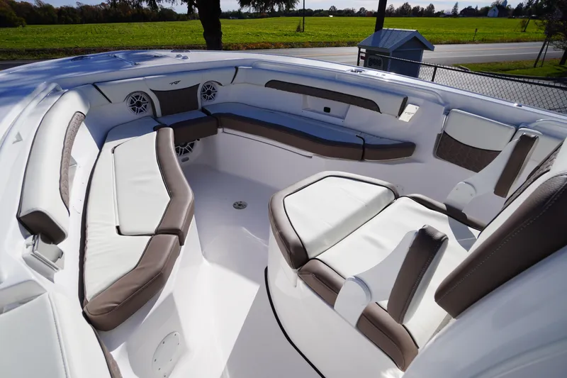Slide: The Image of 2026 Tidewater 256 CC Adventure boat interior with cushioned seating and speaker. - 13