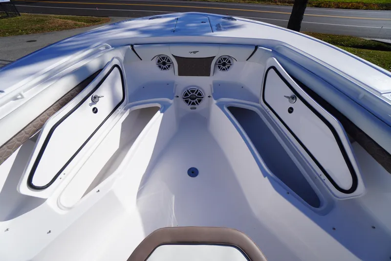 Slide: The Image of 2026 Tidewater 256 CC Adventure boat interior with seating and speakers. - 15