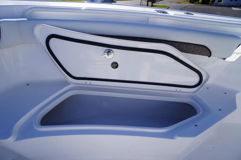 Slide: The Image of 2026 Tidewater 256 CC Adventure boat storage compartment with sleek design and secure latch. - 17