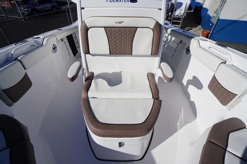 Slide: The Image of 2026 Tidewater 256 CC Adventure boat interior with cushioned seating and modern design. - 19