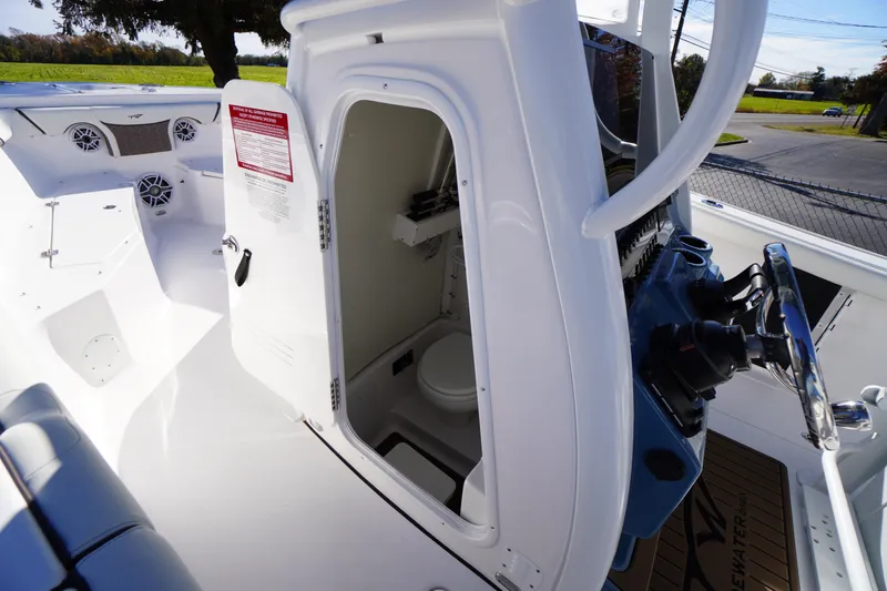 Slide: The Image of 2026 Tidewater 256 CC Adventure boat interior with modern helm and seating. - 23
