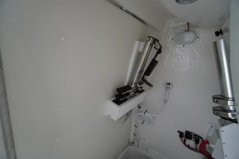 Slide: The Image of 2026 Tidewater 256 CC Adventure boat interior with compact marine toilet. - 26