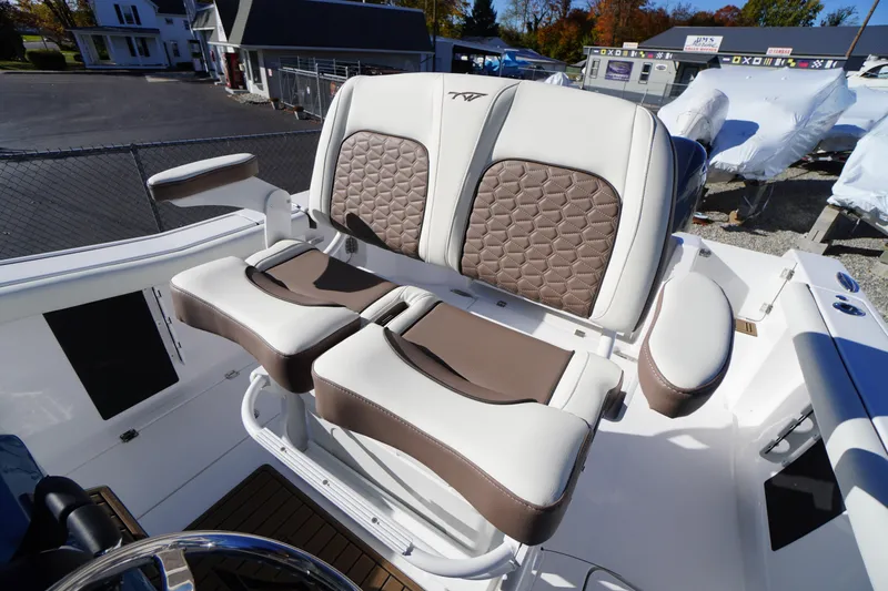 Slide: The Image of 2026 Tidewater 256 CC Adventure boat seating with brown and white upholstery. - 33