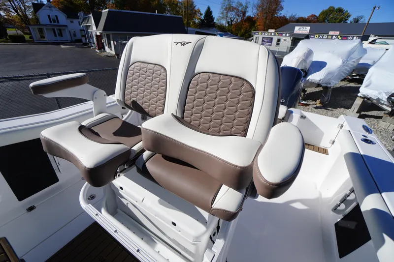 Slide: The Image of 2026 Tidewater 256 CC Adventure boat seating with brown and white upholstery. - 34