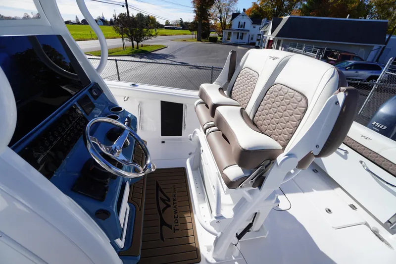 Slide: The Image of 2026 Tidewater 256 CC Adventure boat seats with brown and white upholstery. - 36
