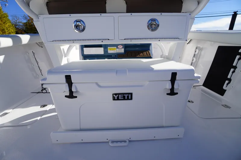 Slide: The Image of 2026 Tidewater 256 CC Adventure boat interior with rod holders and storage compartments. - 38