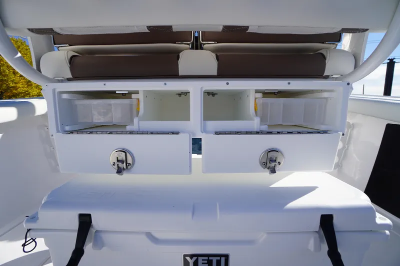 Slide: The Image of 2026 Tidewater 256 CC Adventure boat interior with Yeti cooler and storage compartments. - 39