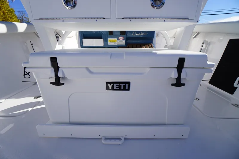 Slide: The Image of 2026 Tidewater 256 CC Adventure boat storage compartments with Yeti cooler. - 40