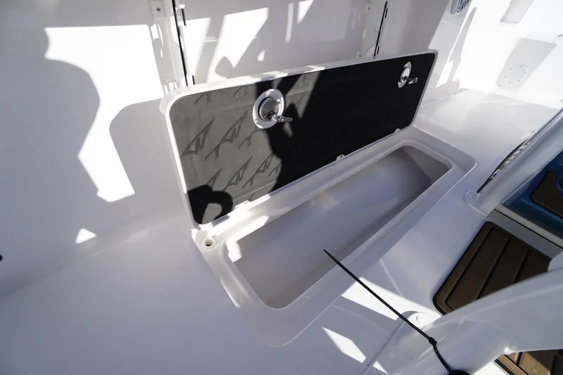 Slide: The Image of 2026 Tidewater 256 CC Adventure boat interior with rod holders and storage compartments. - 42