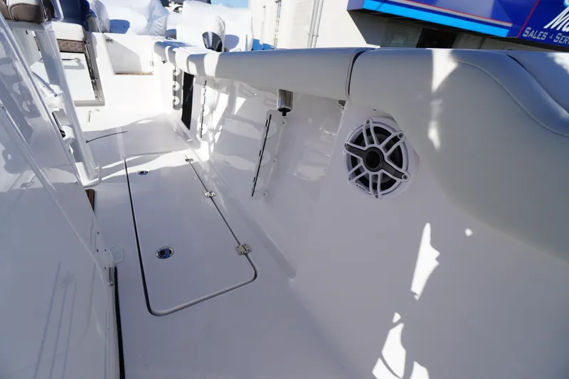 Slide: The Image of 2026 Tidewater 256 CC Adventure boat interior with white deck and seating. - 44
