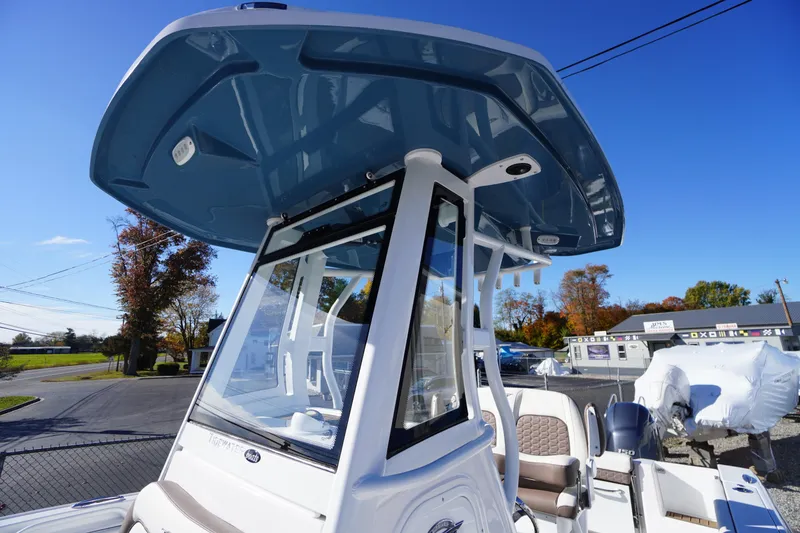 Slide: The Image of 2026 Tidewater 256 CC Adventure boat interior with speaker and seating area. - 45