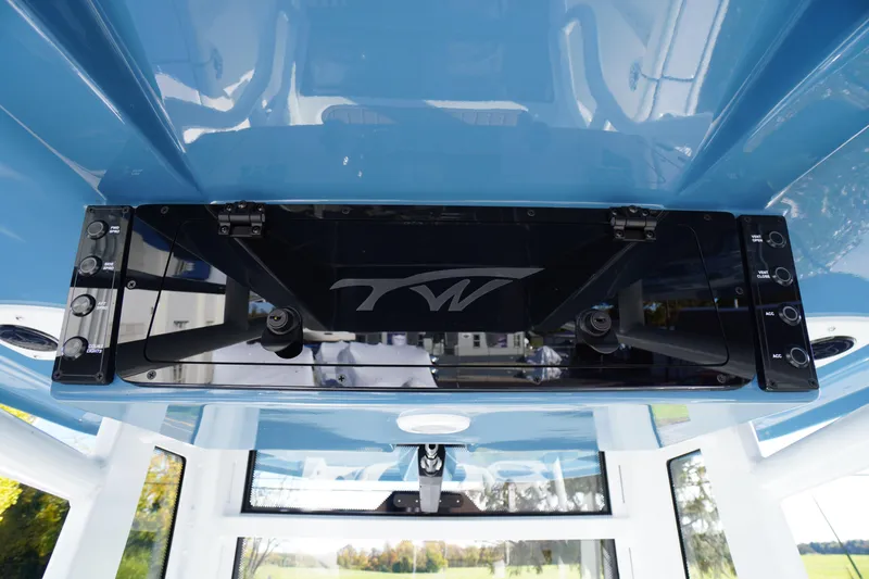 Slide: The Image of Interior view of 2026 Tidewater 256 CC Adventure boat cockpit with compass and windshield. - 49