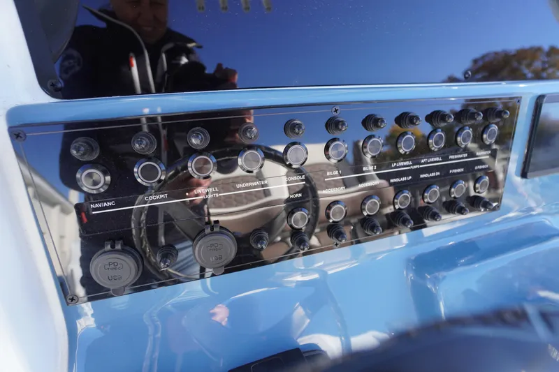 Slide: The Image of 2026 Tidewater 256 CC Adventure boat detail, featuring a sleek blue and white design. - 51