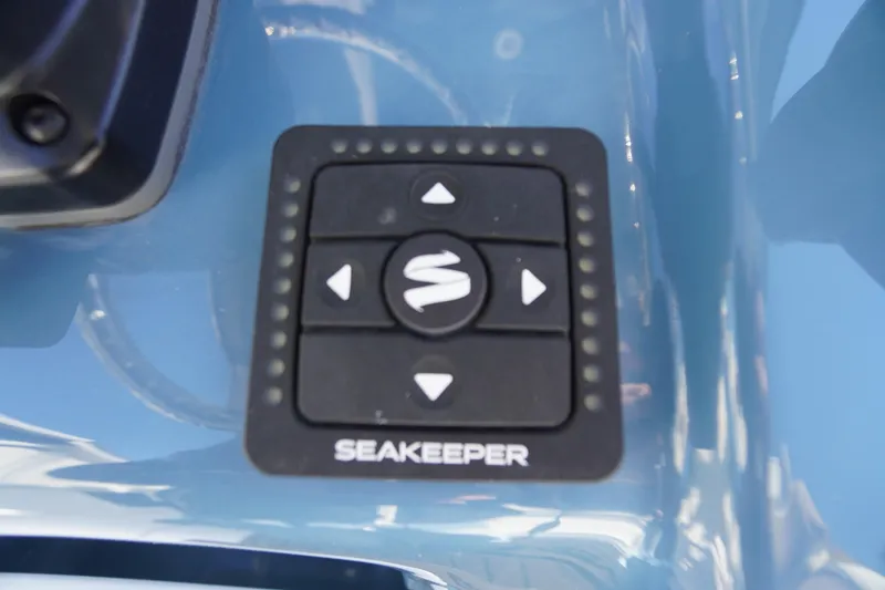 Slide: The Image of Control panel of 2026 Tidewater 256 CC Adventure boat with various switches and USB ports. - 52