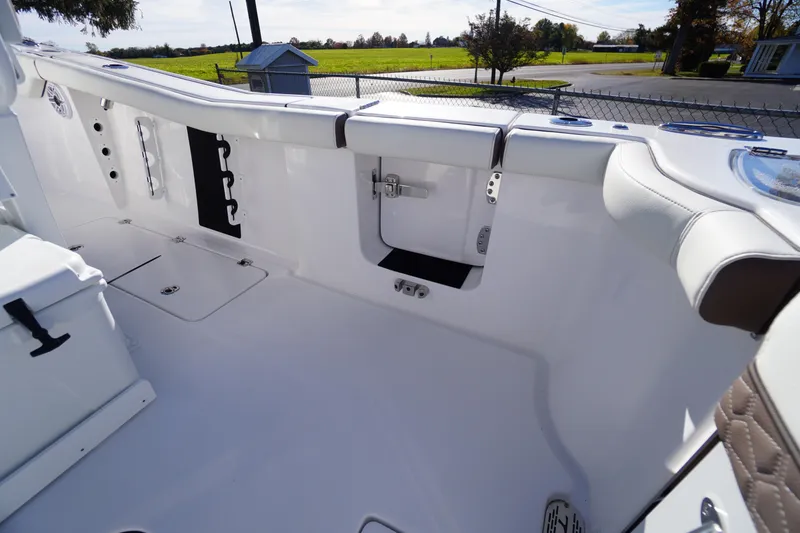 Slide: The Image of 2026 Tidewater 256 CC Adventure boat interior with dual engines and seating area. - 56