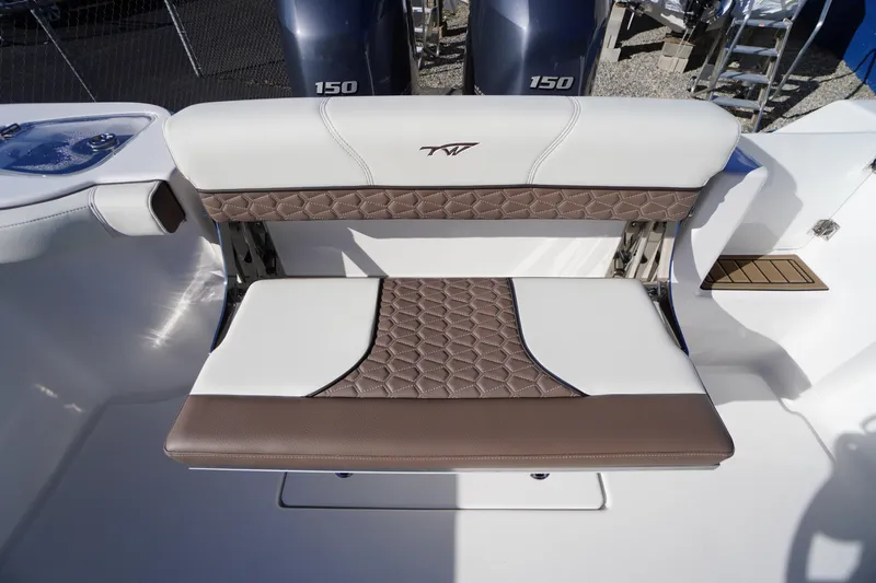 Slide: The Image of 2026 Tidewater 256 CC Adventure boat interior with seating and dual Yamaha 150 engines. - 62