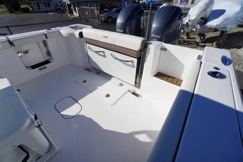 Slide: The Image of 2026 Tidewater 256 CC Adventure boat interior with cushioned seating and dual engines. - 63