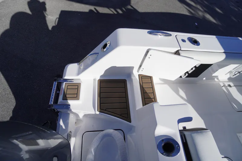 Slide: The Image of 2026 Tidewater 256 CC Adventure boat with dual Yamaha 150 engines, docked outdoors. - 67