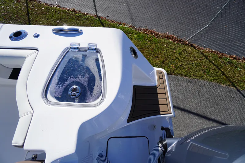 Slide: The Image of 2026 Tidewater 256 CC Adventure boat interior with seating and storage features. - 69