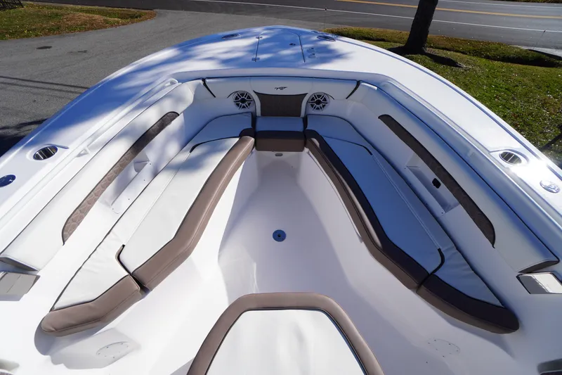Slide: The Image of 2026 Tidewater 256 CC Adventure boat anchor compartment, open lid, sunny day. - 7