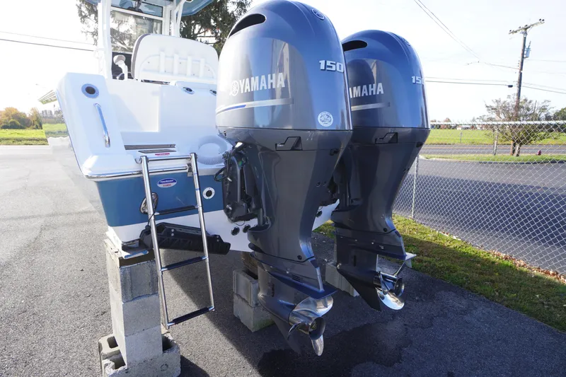 Slide: The Image of 2026 Tidewater 256 CC Adventure with dual Yamaha 150 outboard engines, rear view. - 72